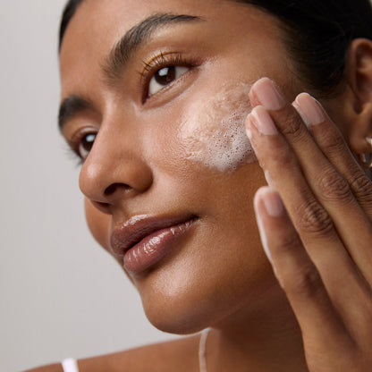 Model application showcasing the Tatcha Rice Wash